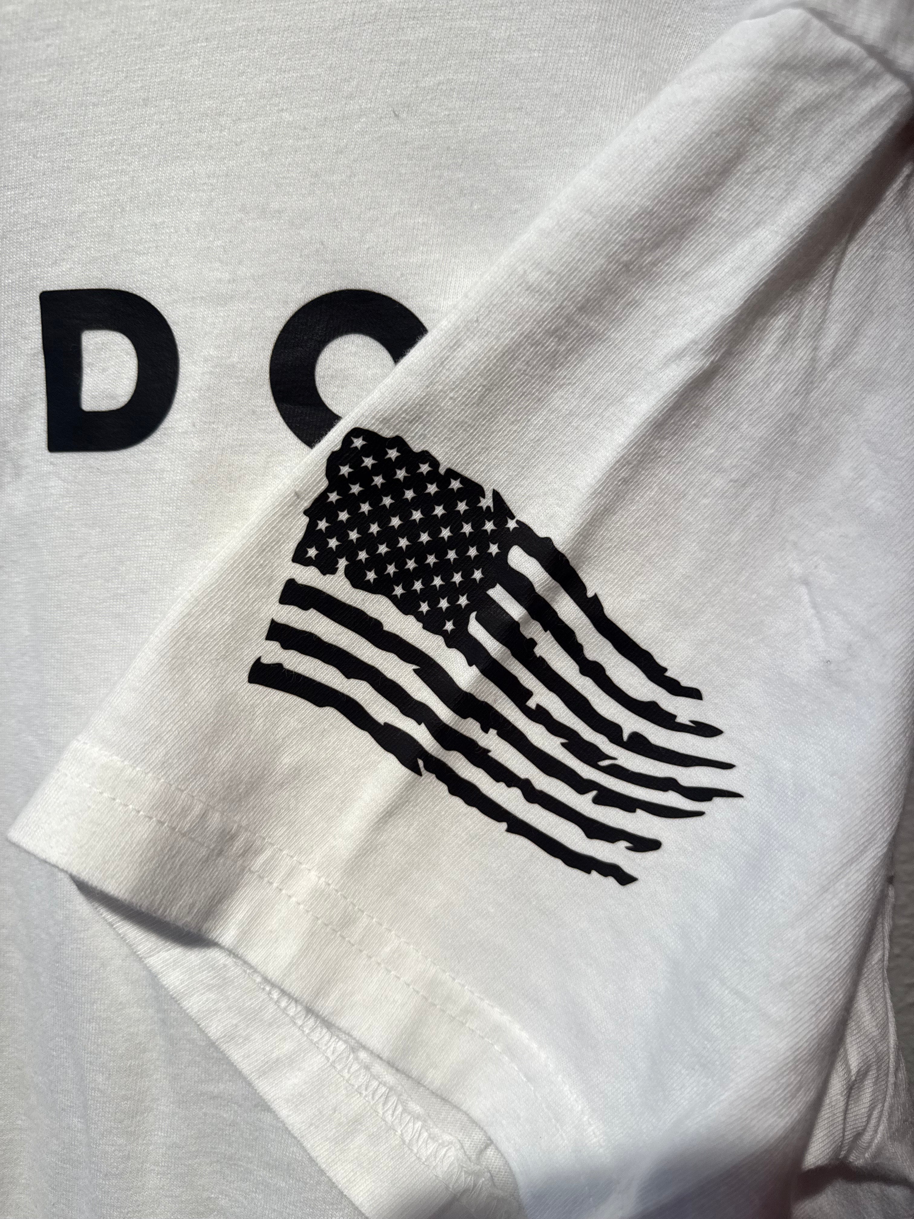 White shirt with black American flag design and 'DC' letters on a white background